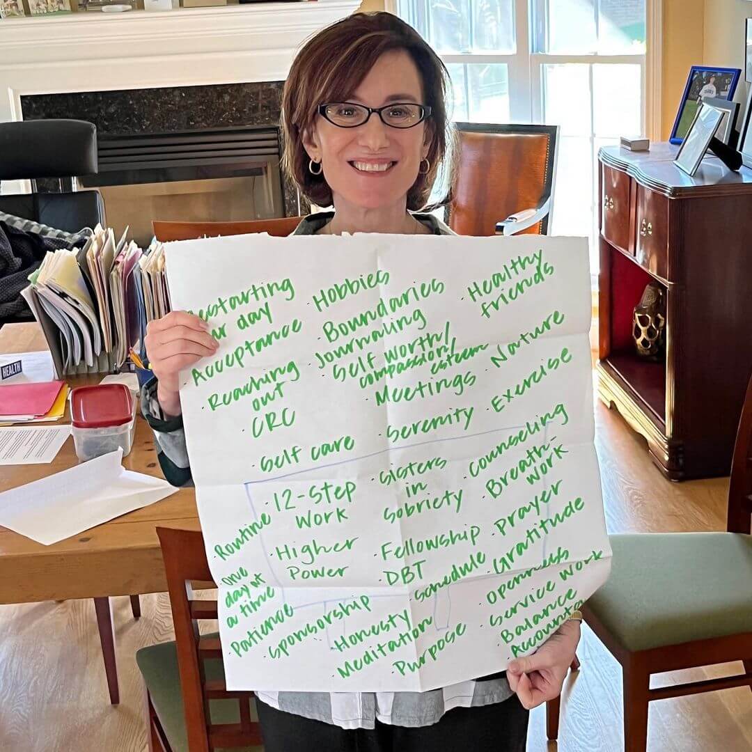 Picture of Susan Packard holding up a poster with recovery tools. These are just some of the tools sober college students use to help with their recovery. They embrace solutions, a wonderful work and life skill! Click to zoom in, or head to the Resources page for more.