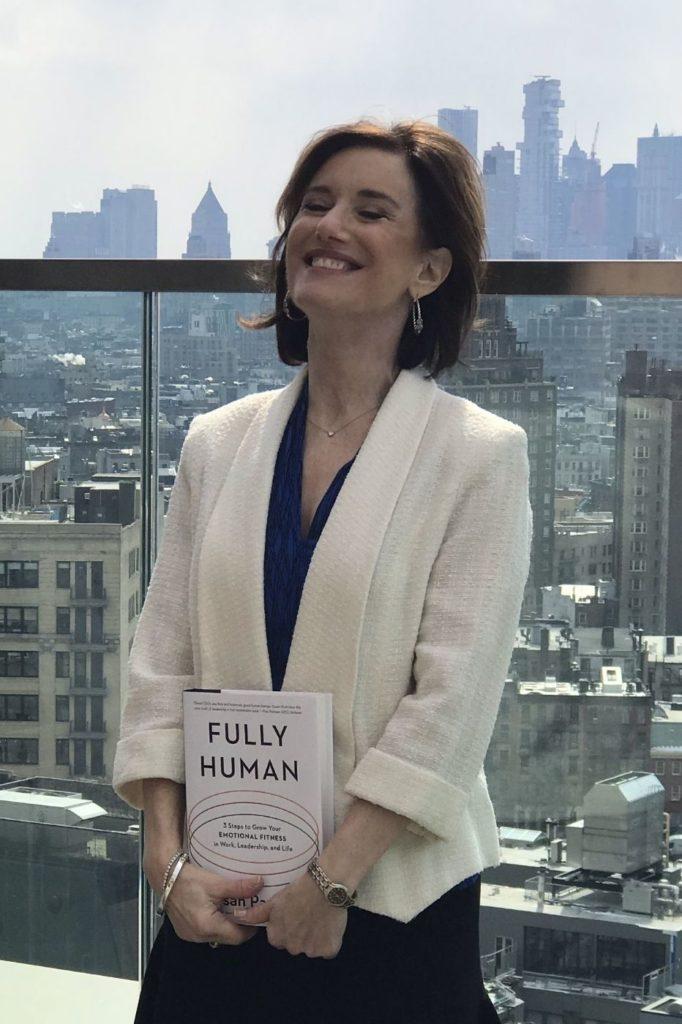 Susan Packard holding a copy of "Fully Human"